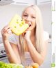 beautiful-young-blond-woman-eating-cheese-home-kitchen-blond-woman-eating-cheese-121740414.jpg
